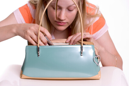 Young Caucasian woman looking in her purse
