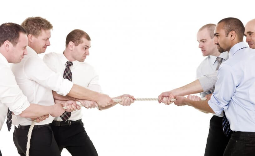 Six men in shirt and tie with pulled sleaves playing tug-o-war to illustrate ways to resolve conflicts