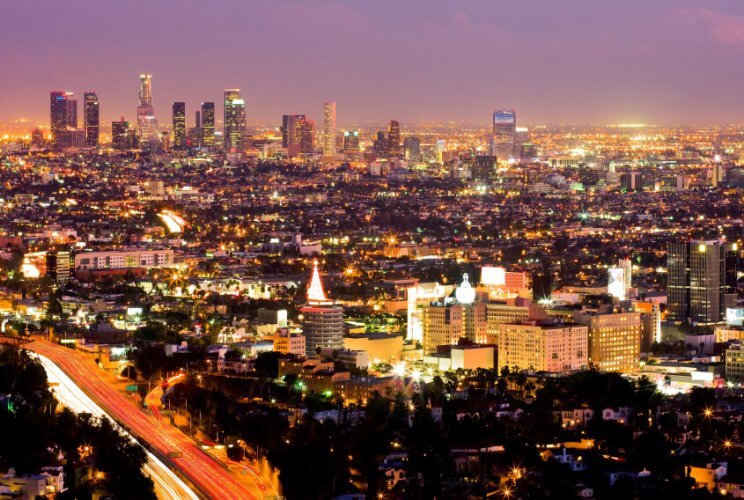 Skyline of Los Angeles during sunset with the city already lit up.