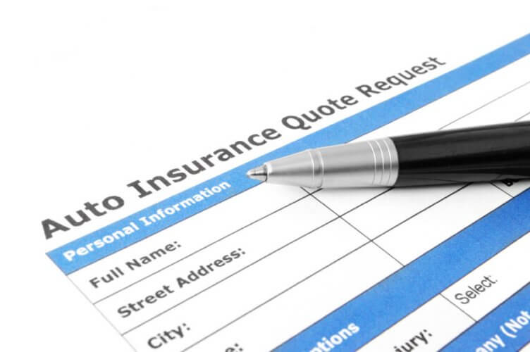 Close up to an Auto Insurance Quote Request form with a pen on top