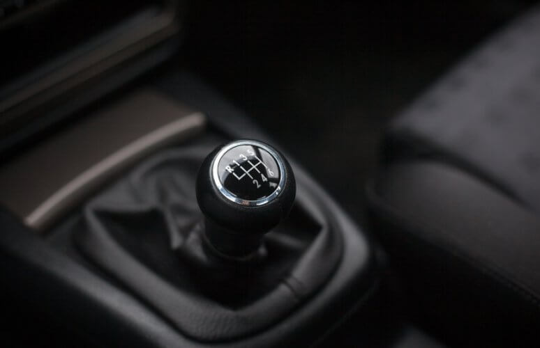 Close-up to the gear lever of a manual-transmission vehicle