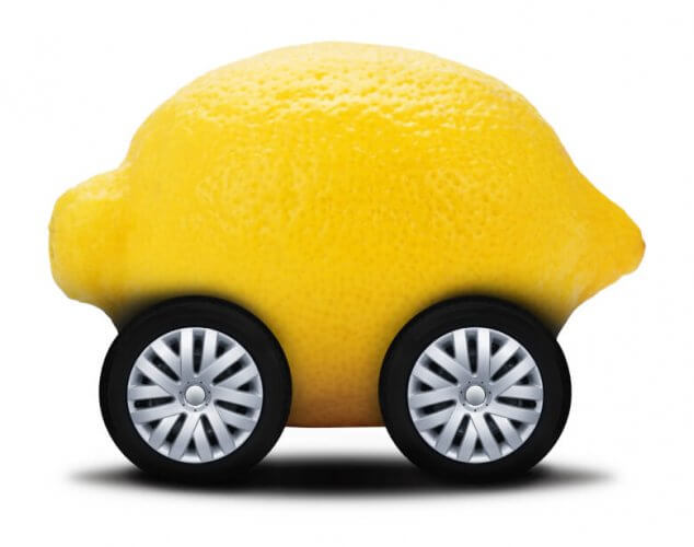 Close up to a lemon with wheels as if it were a vehicle.
