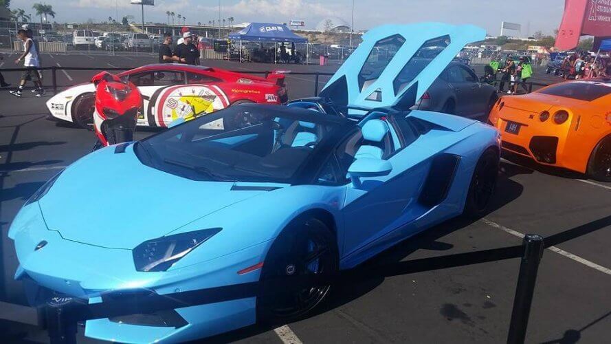 Blue Lamborghini in front of other luxury cars in the Anaheim Dub Show 2014