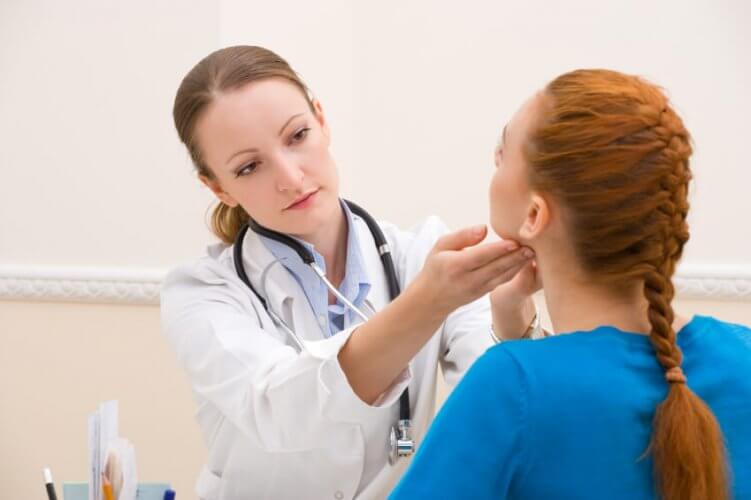 Young female doctor examines a young female patient at a doctor's office