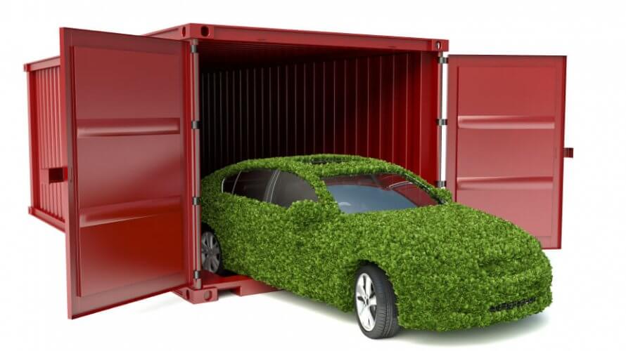 Plant-covered car driving out of a metal storage container to portray the concept of the eco-frienly car