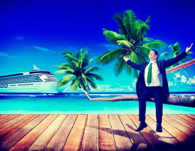 Joyful worker on vacation stands on wooden dock with cruise and palm trees behind him to illustrate vacation from work