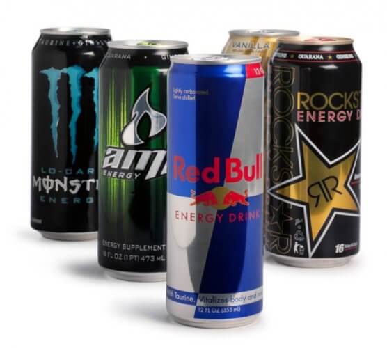 Several cans of many energy drink brands placed together on a white background