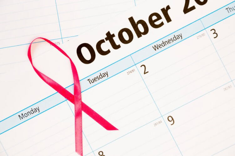 October calendar sheet with a pink ribbon on top symbolizing Breast Cancer Awareness Month