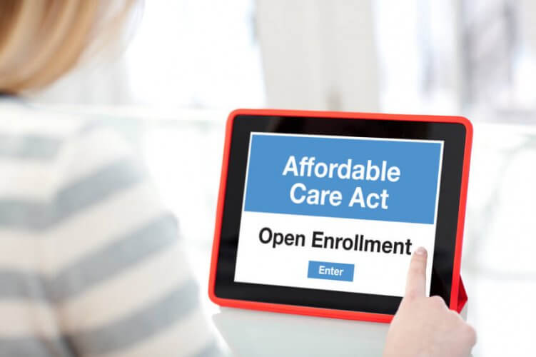 Woman looking at iPad ready to enter the Affordable Care Act Open Enrollment