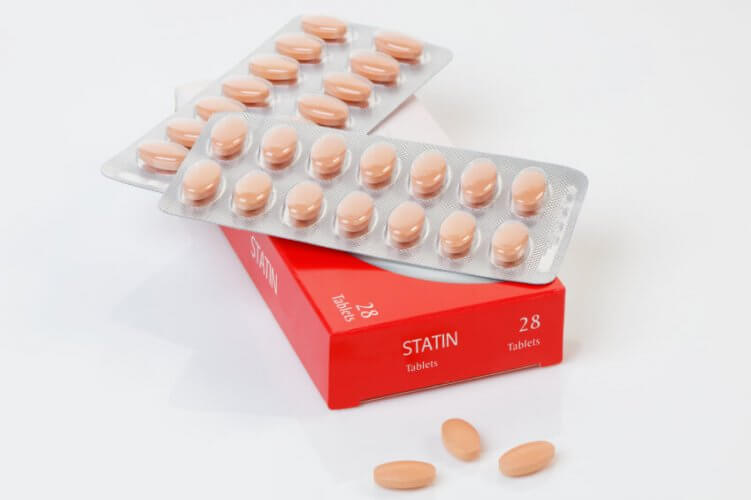 Statins medicine capsules on top of the medicine box.