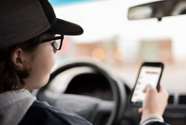 Image of New York Cops Looking at Device to Detect Texting Drivers