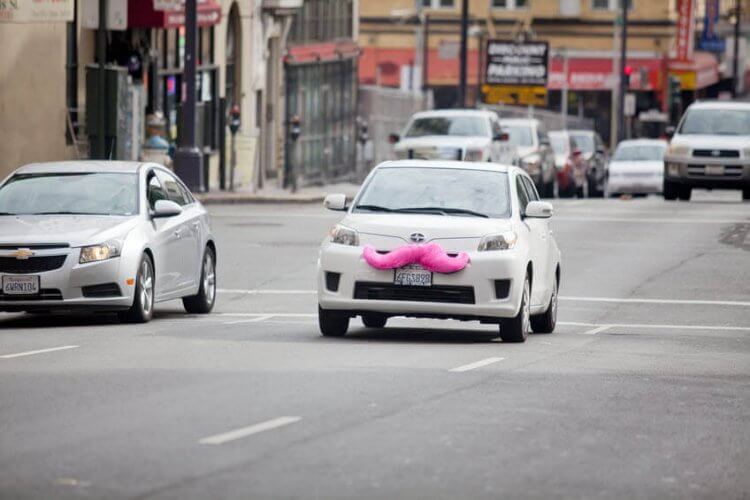 A Scion car wearing a pink moustache to showcase that ride-Sharing Service Lyft to Trim Iconic Pink Mustache