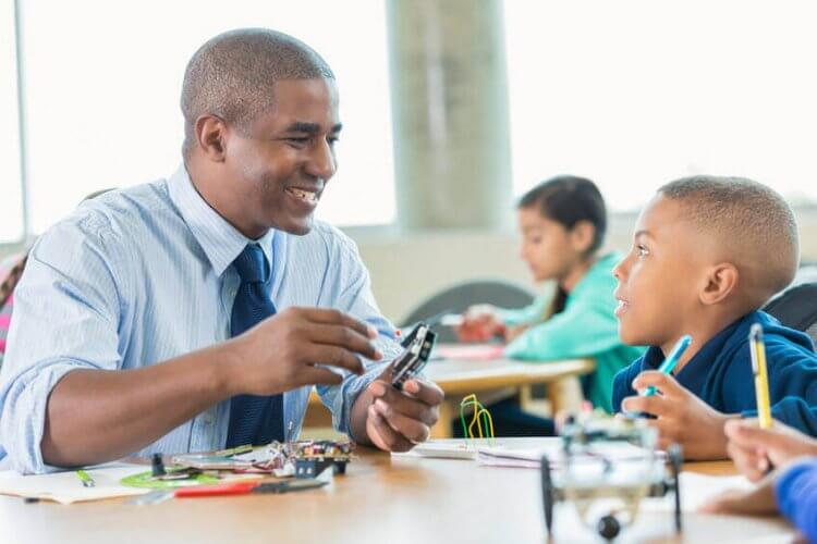 A father assembling an robot kit with his son to illustrate a few Back to School Tips, Tricks, Dos and Don'ts for Overwhelmed Parents