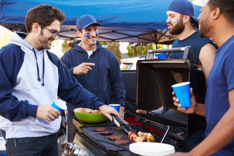 A group of Caucasian friends grilling in a parking lot to illustrate that Accidents Happen and how to Legally protect Yourself When You Host a Party