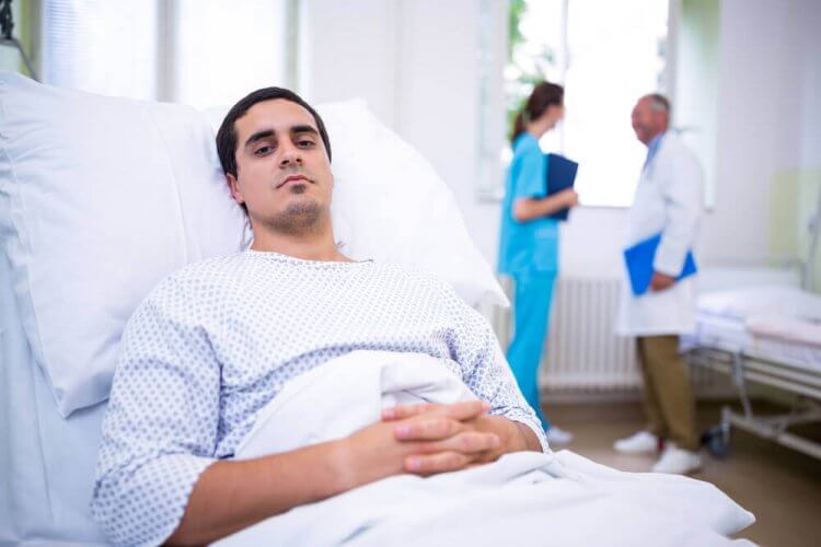Ill patient lying on bed in hospital to portray a hospital indemnity plan