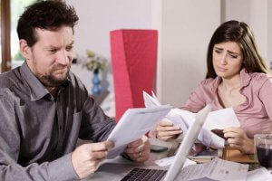 Unhappy couple looking at their penalty for not having health insurance.
