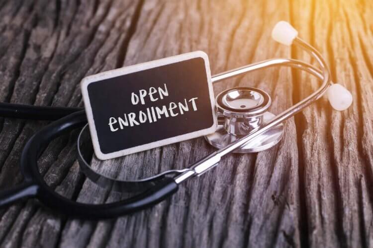 Stethoscope next to a piece of paper that reads open enrollment to illustrate that open enrollment has ended.