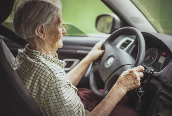 Elderly woman driving a car to illustrate whether elderly drivers are a safety hazard