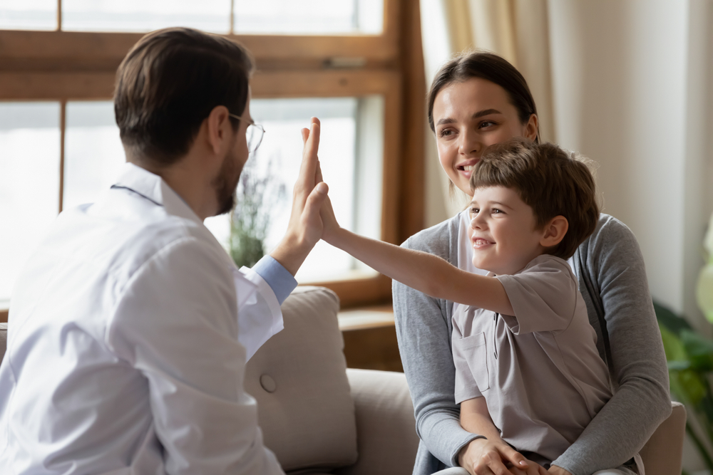 Smiling mother and young child with doctor