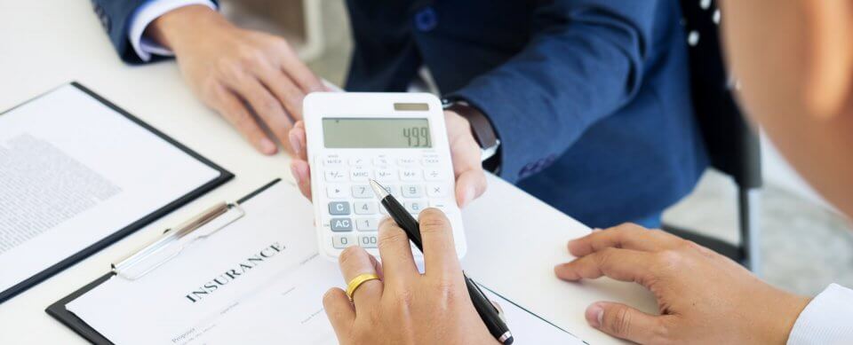 An insurance agent showing an insurance rate to a potential customer who is about to purchase a car insurance policy.