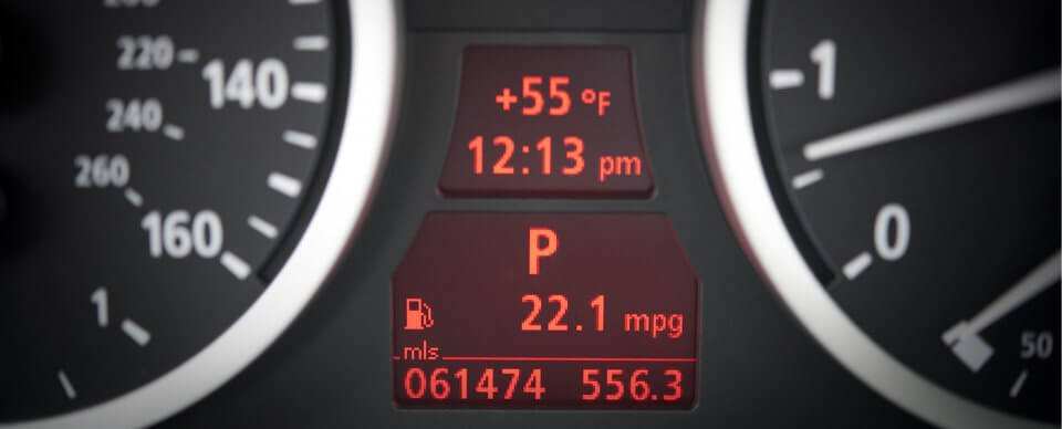 Close up to the fuel consumption information part of a car's dashboard to illustrate how to get more miles per gallon.