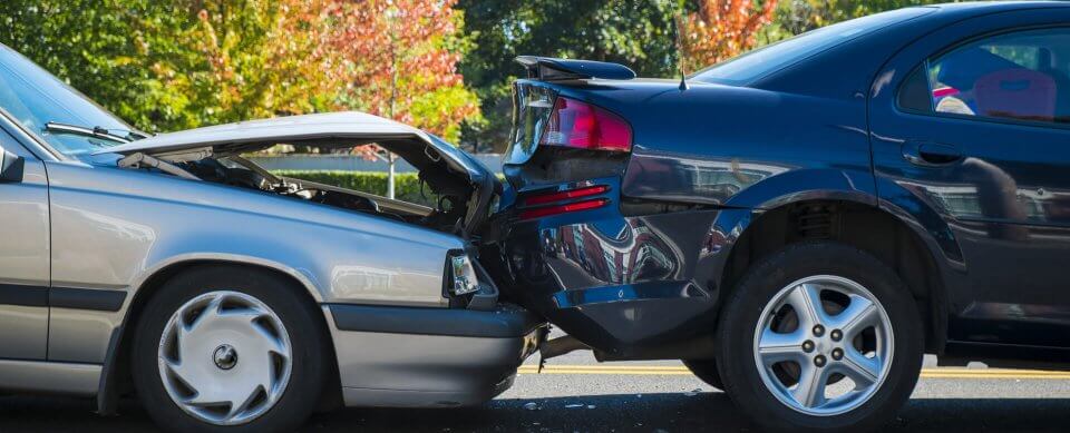 Two damaged vehicles after a crash to illustrate the 5 most common types of car accidents