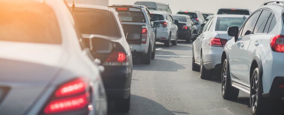 A traffic jam on a busy road to illustrate how does sitting in rush hour traffic affect insurance rates.