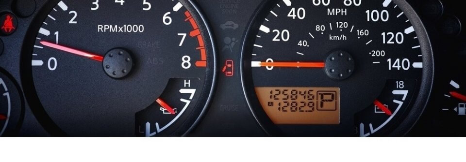 Closeup of car odometer with high mileage to illustrate when is buying a high-mileage car a bad idea.