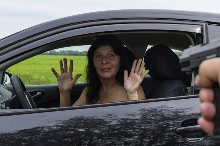 woman in car being carjacked