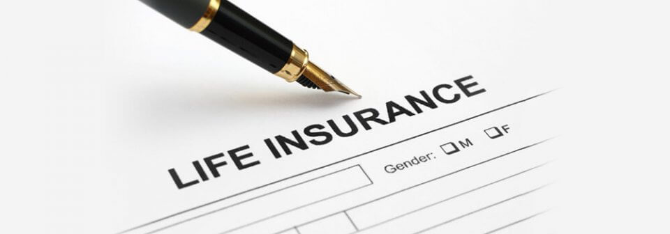 A close-up of life insurance applications and pen to illustrate 10 factors that affect your life insurance premium.