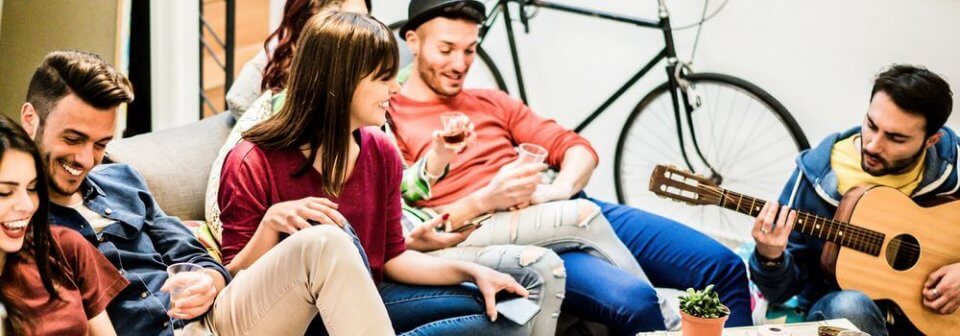 Group of friends having a party in an apartment. Remember to protect yourself when having a party with the right insurance cover.