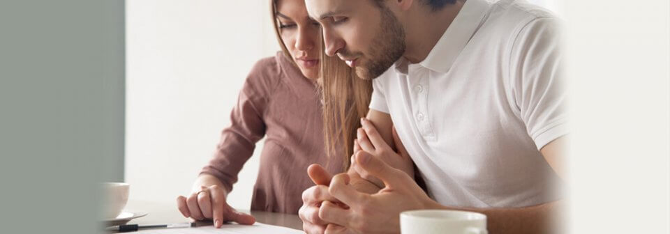 Young couple reviewing health insurance information online and learning how does health insurance work.