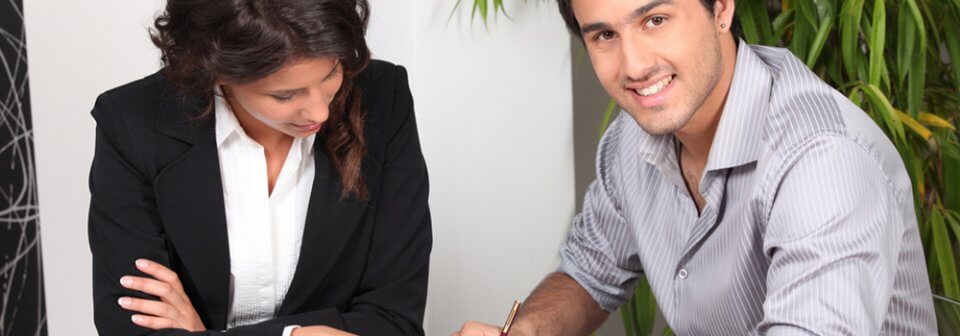 A young latino tenant filling out an application to rent an apartment to portray what to expect when screening for tenants.