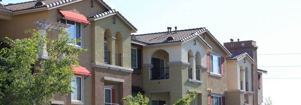 Modern apartment complex in a suburban neighborhood illustrates the importance of landlord insurance.