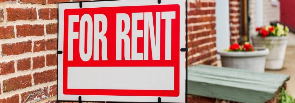 A For Rent sign placed in front of a house to illustrate what is landlord insurance.