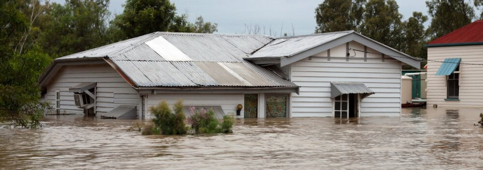 A house that was flooded during a flood depicting which items are covered in a flood.