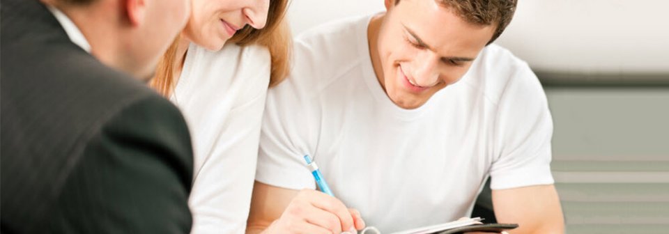 A man signing an insurance policy form to purchase coverage with a new insurance company.