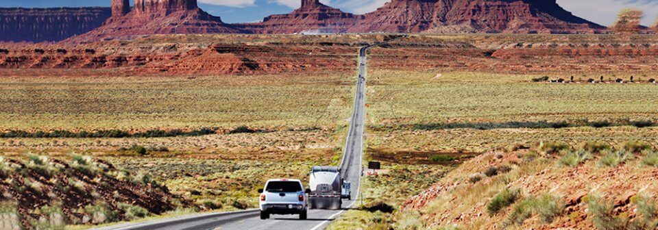Several cars driving down a road in the Arizona dessert to illustrate the insurance requirements and coverage for Arizona.
