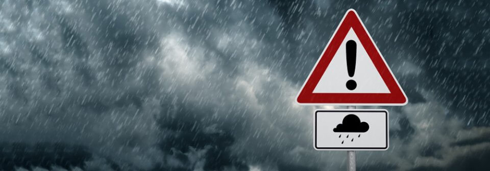 A road sign warning about storms to illustrate homeowner's insurance mistakes that could prove costly.