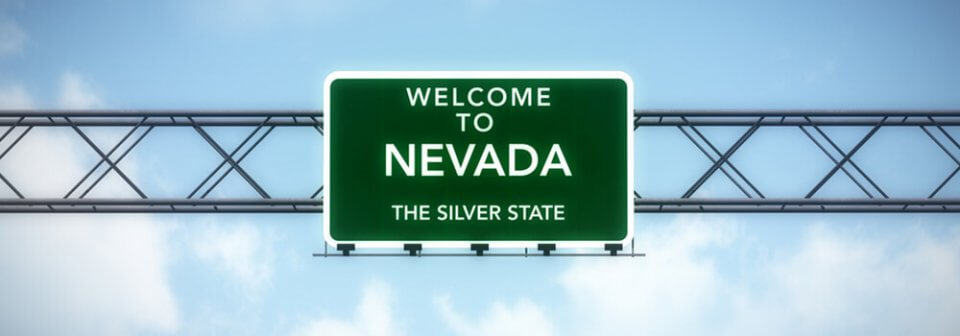 An overhead road sign that reads Welcome to Nevada to depict the insurance requirement in the state of Nevada.