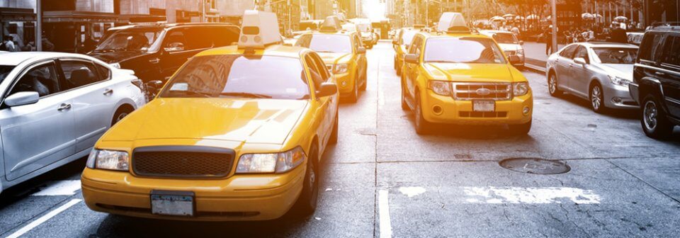 Several cabs and other cars stuck in traffic to illustrate the insurance requirements and coverage for New York.