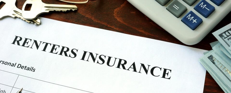 A renters insurance application next to a keyset, calculator and stack of dollar bills to illustrate what you should know about renter's insurance.