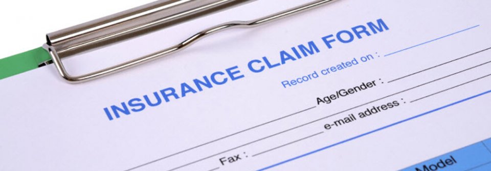 A clipboard with an insurance claim form to illustrate how to avoid these mistakes on your car insurance claim.