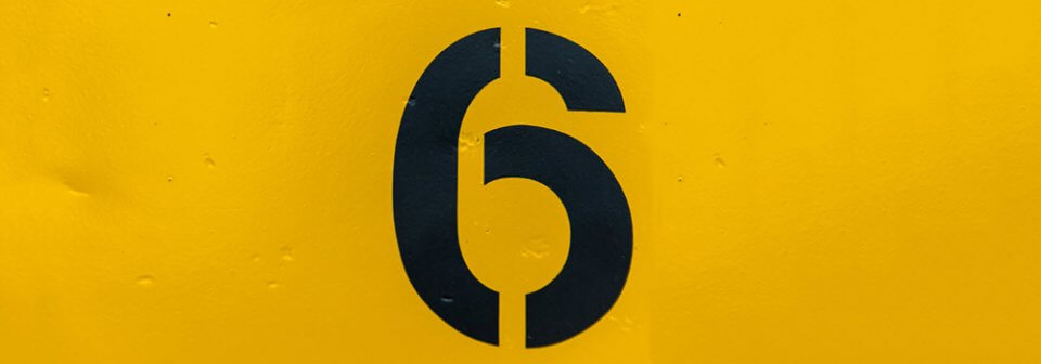 A stencil-painted number six that illustrates that most car insurance policies are only for six months.