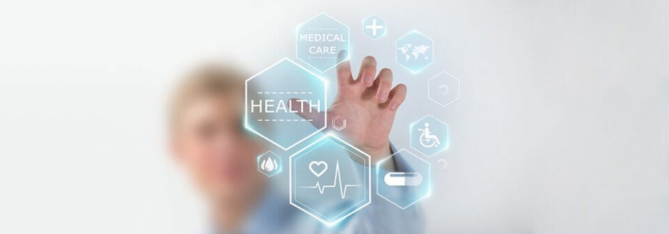 A man touching an electronic button that reads medical care with his finger with other types of insurance in similar buttons aside.