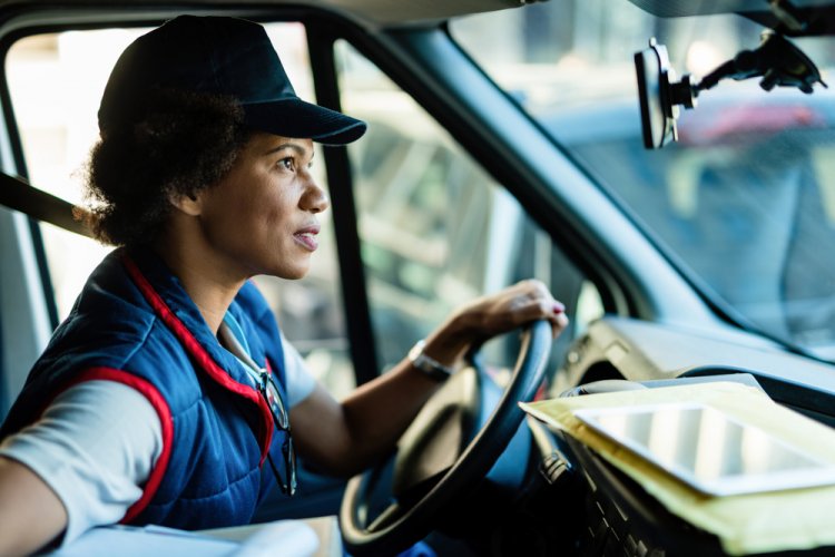 african american female truck driver on her truck with commercial insurance