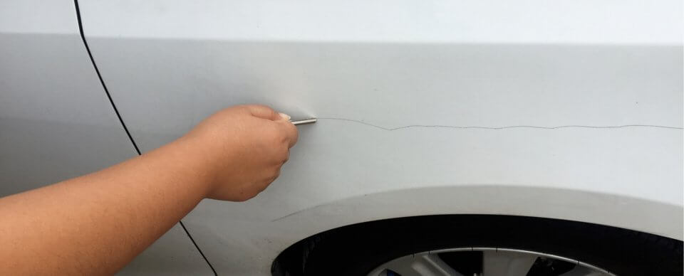 A person keying another person's car, which might be covered by car insurance.