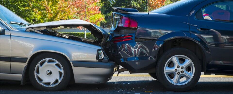 Close-up to the damage caused during a car crash to illustrate the importance of liability auto insurance