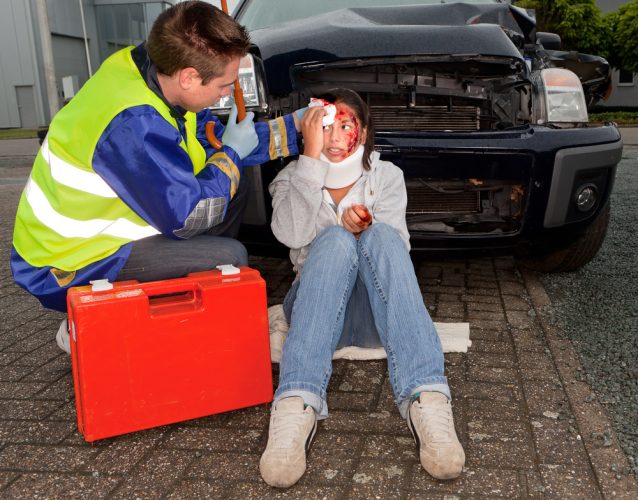 Medic tends to young woman injured in car accident