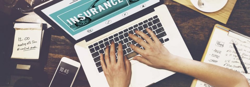 Close-up to a person searching for insurance online after learning 5 insurance tips for car-buyers.